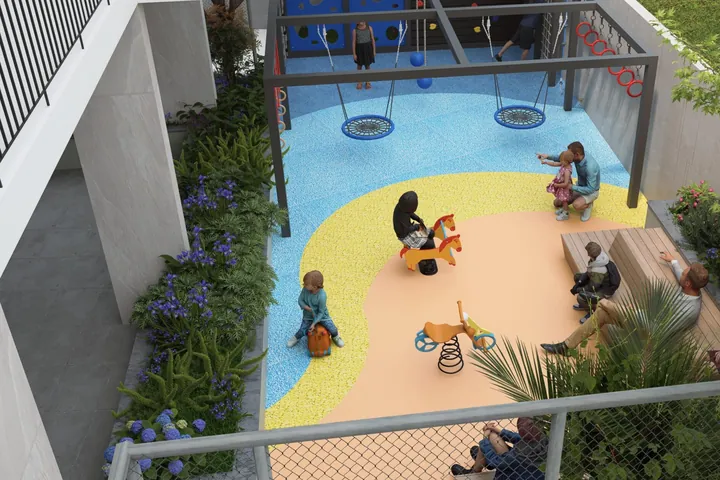 A children’s play area with swings and spring riders